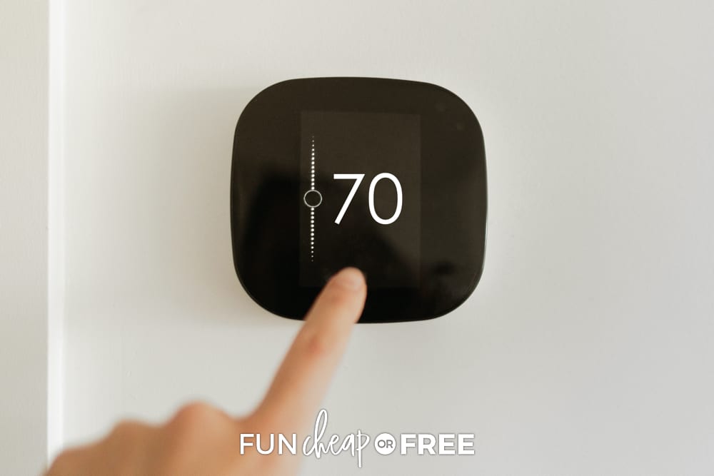 Finger turning smart thermostat down, from Fun Cheap or Free