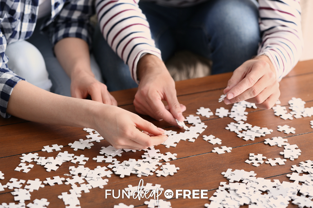 couple putting together a puzzle, from Fun Cheap or Free