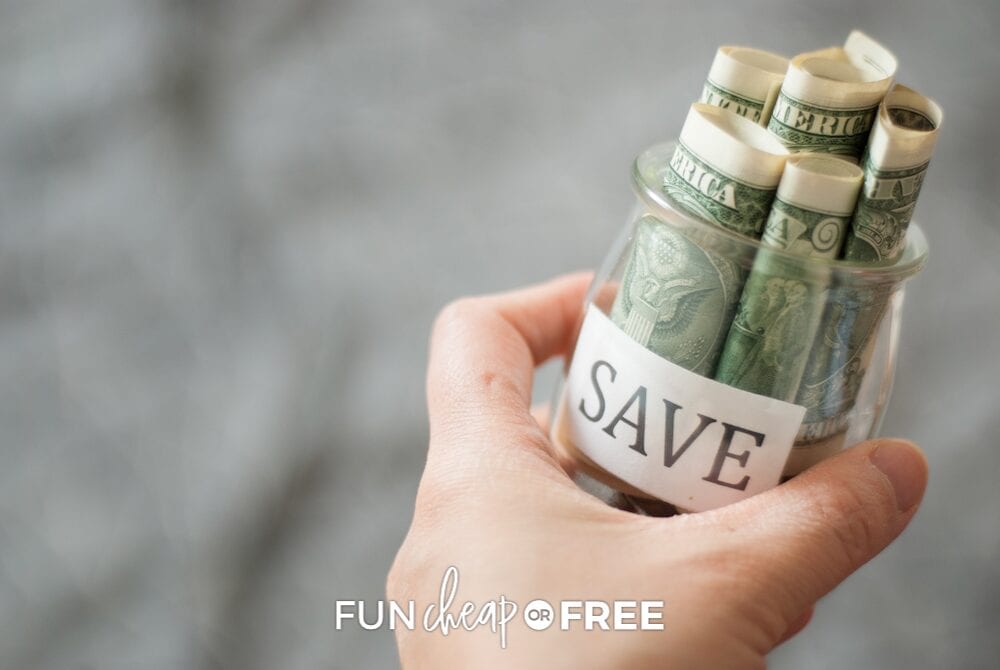 Hand holding a savings jar with cash for emergency preparedness, from Fun Cheap or Free