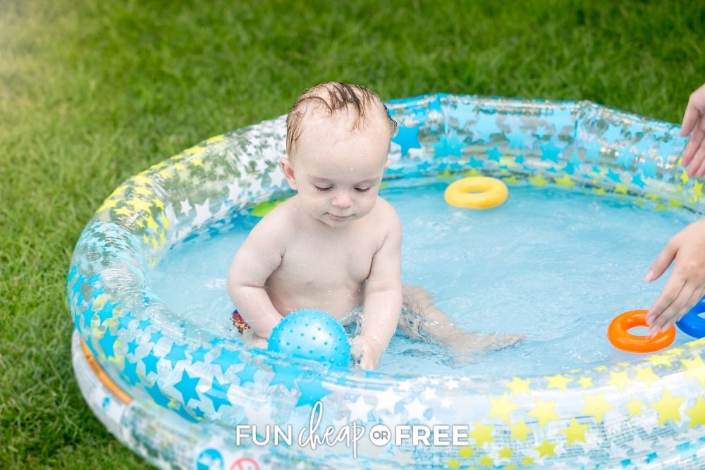 little boy playing in kiddie pool