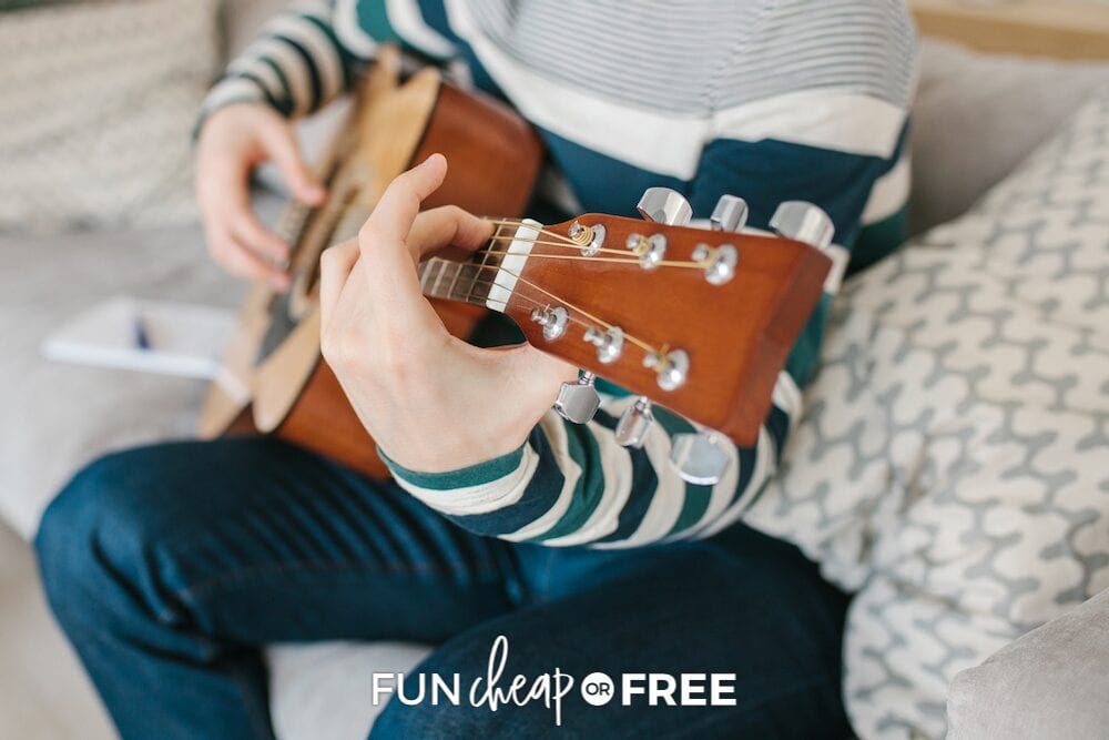 boy learning how to play guitar, from Fun Cheap or Free