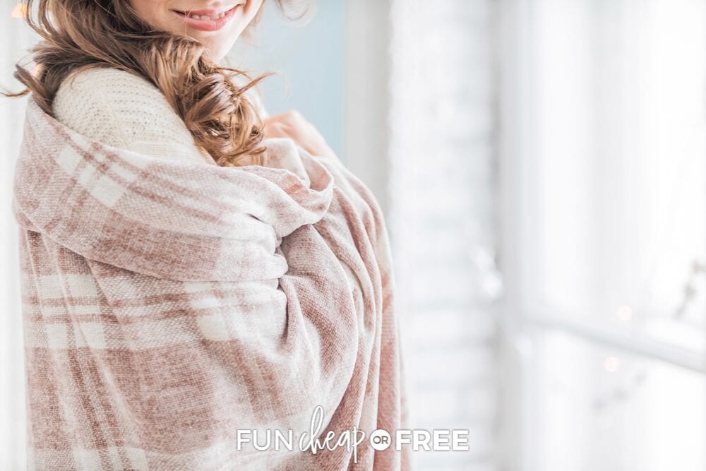 Woman wrapped up in a graduation gift blanket, from Fun Cheap or Free