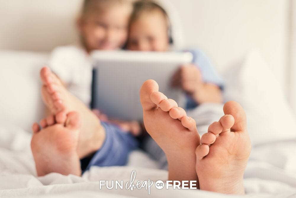 Kids watching an iPad in bed, from Fun Cheap or Free