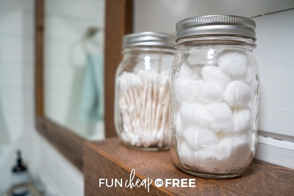 hanging jars on the wall holding cotton balls, from Fun Cheap or Free