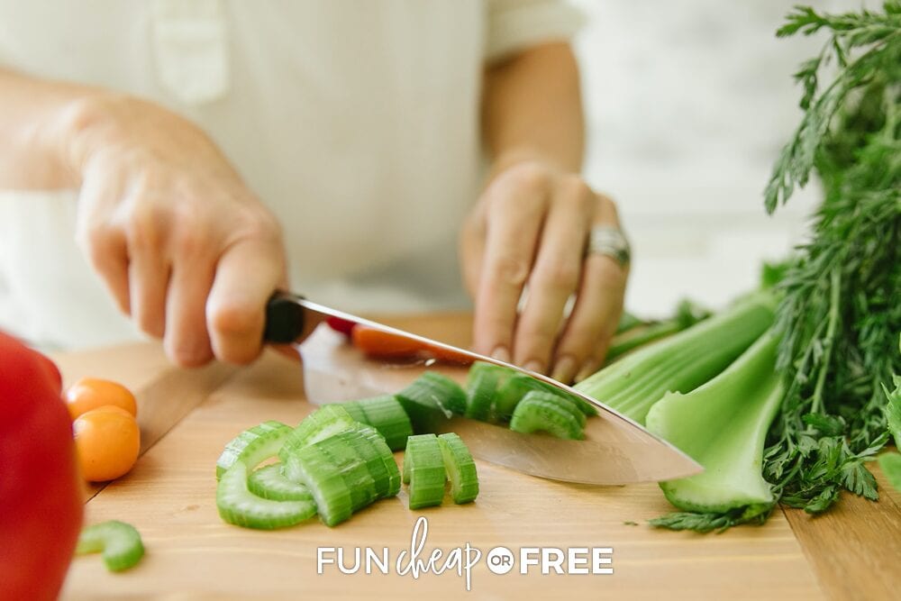 Hands chopping celery on a cutting board, from Fun Cheap or Free