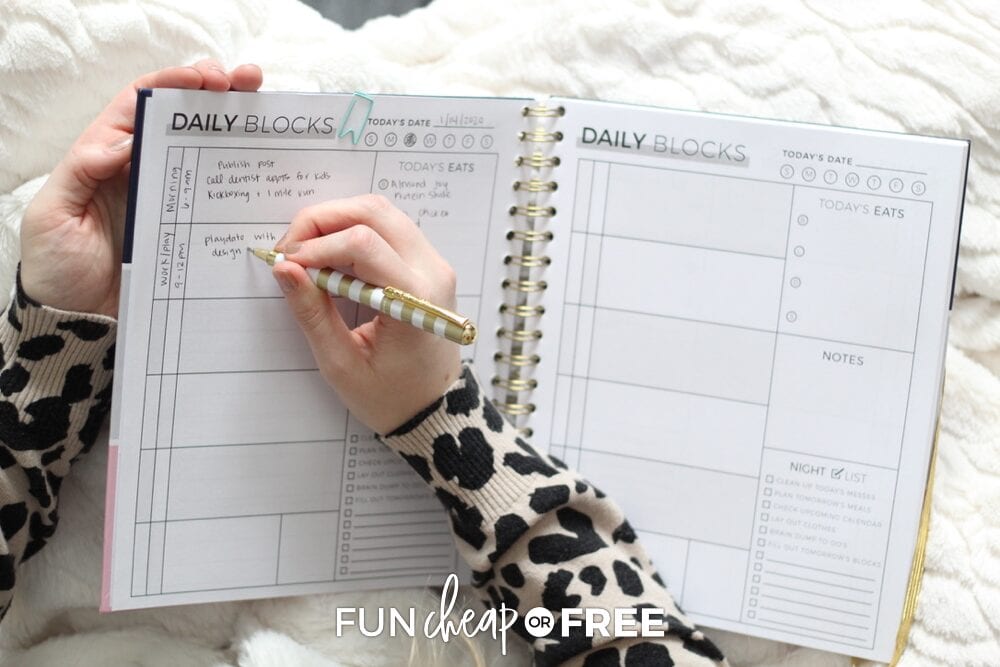 Woman writing in her Productivity Planner block schedule, from Fun Cheap or Free