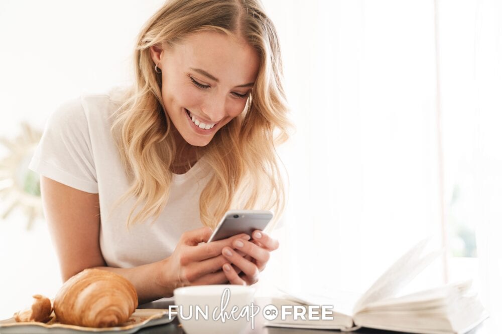 Woman smiling while looking at her phone, from Fun Cheap or Free