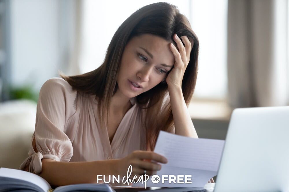Woman holding bill of unexpected expenses, from Fun Cheap or Free