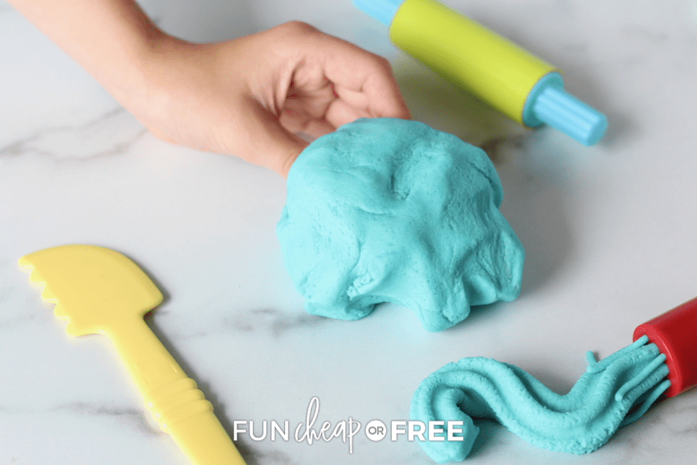 blue playdough and toys on a marble counter, from Fun Cheap or Free