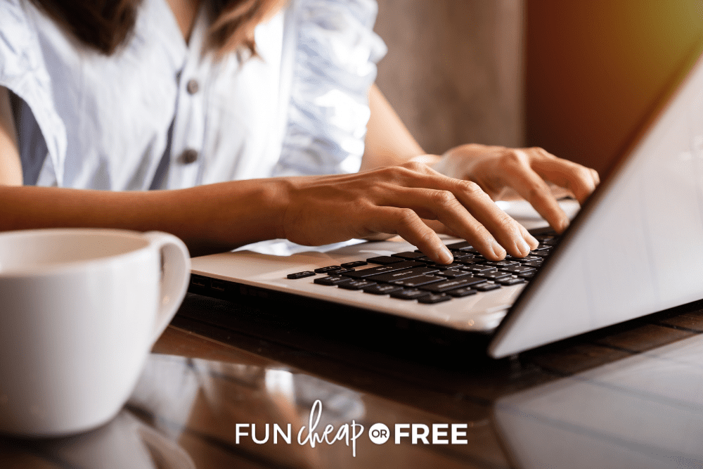 Woman sitting at a table shopping on a laptop, from Fun Cheap or Free
