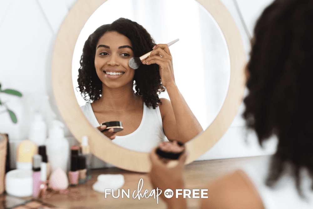 woman sitting at mirror putting on blush, from Fun Cheap or Free