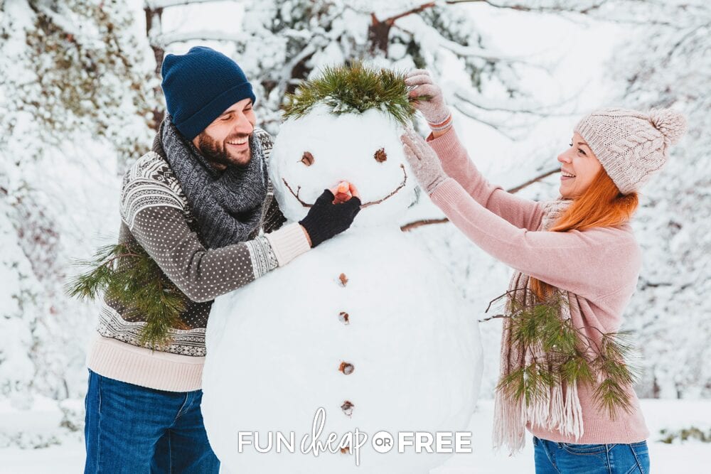 Couple building a snowman during winter date, from Fun Cheap or Free