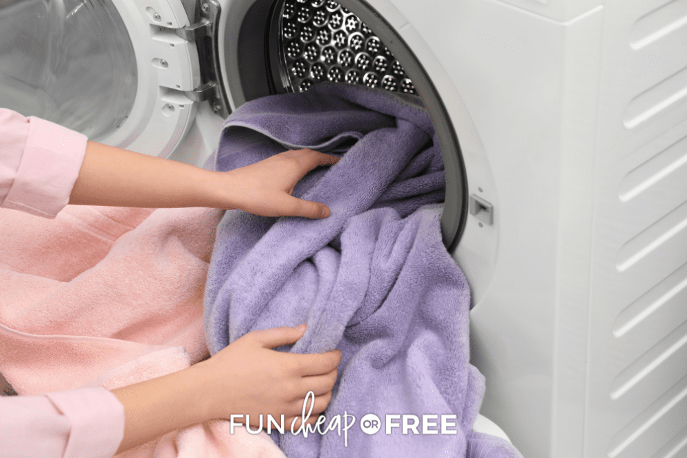 woman taking towels out of the dryer, from Fun Cheap or Free