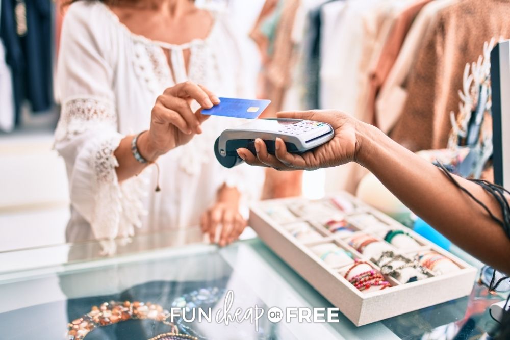 woman paying with a credit card in store, from Fun Cheap or Free
