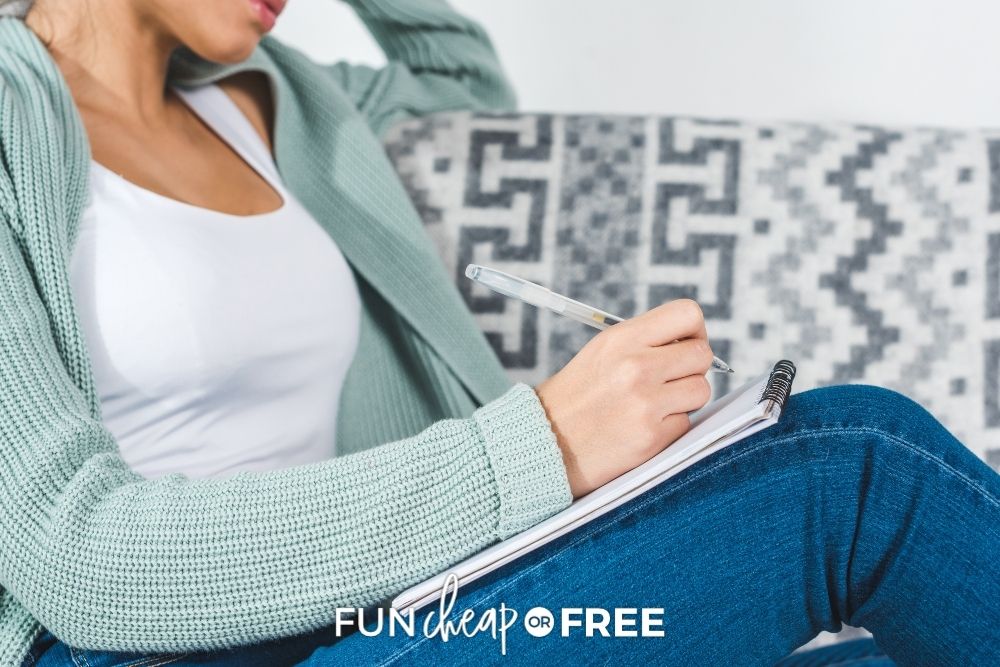 Woman writing in gratitude journal from Fun Cheap or Free. 