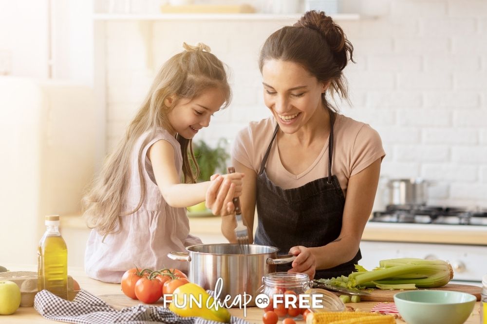 Mom and daughter making a meal together and smiling from Fun Cheap or Free. 