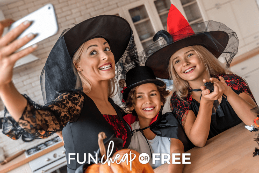 Image of a mother, son, and daughter in Halloween costumes. They are posing for a selfie in their kitchen. - Fun Cheap Or Free